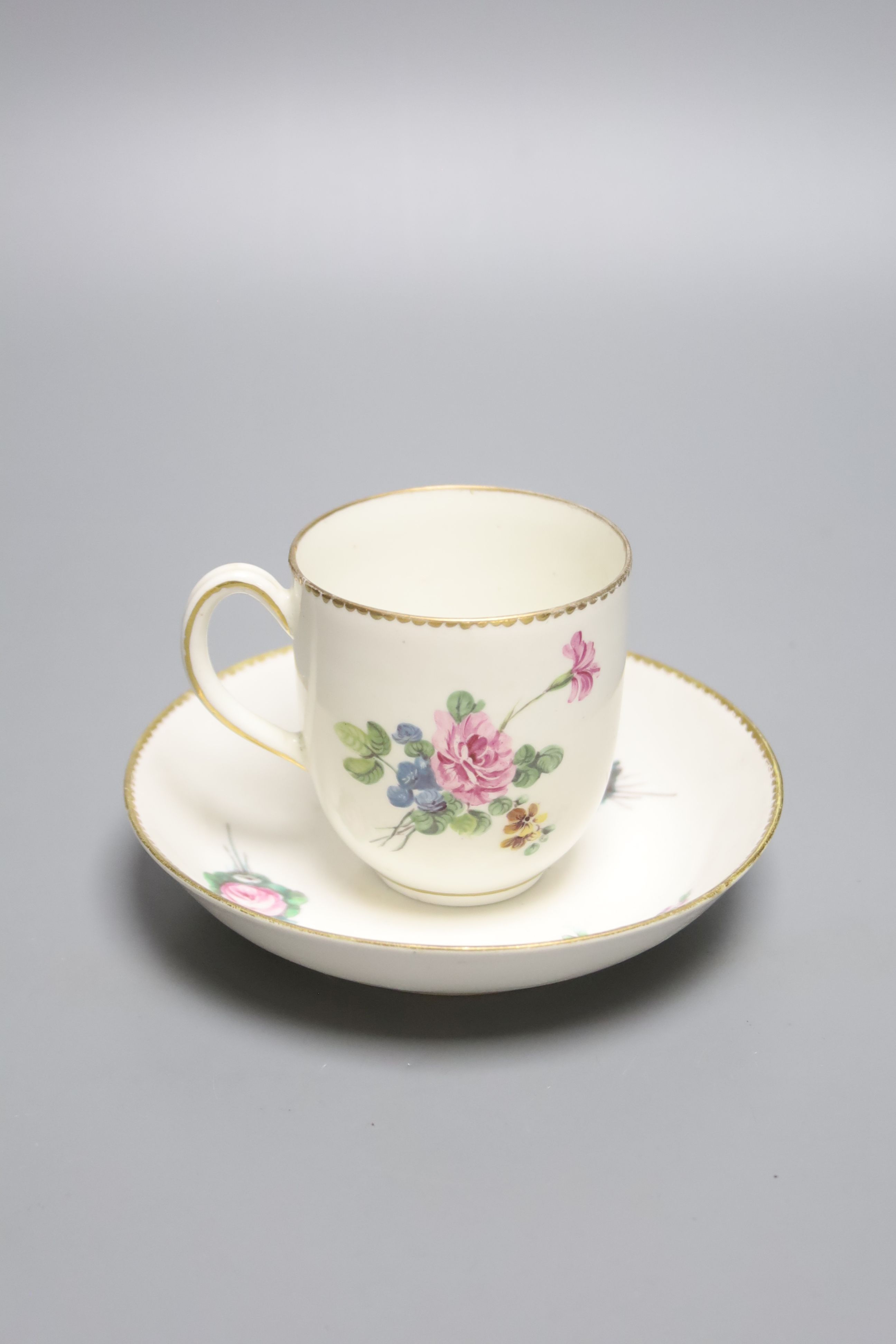 A large Derby coffee or chocolate cup and saucer painted with sprays of flowers by Wm. Billingsley,